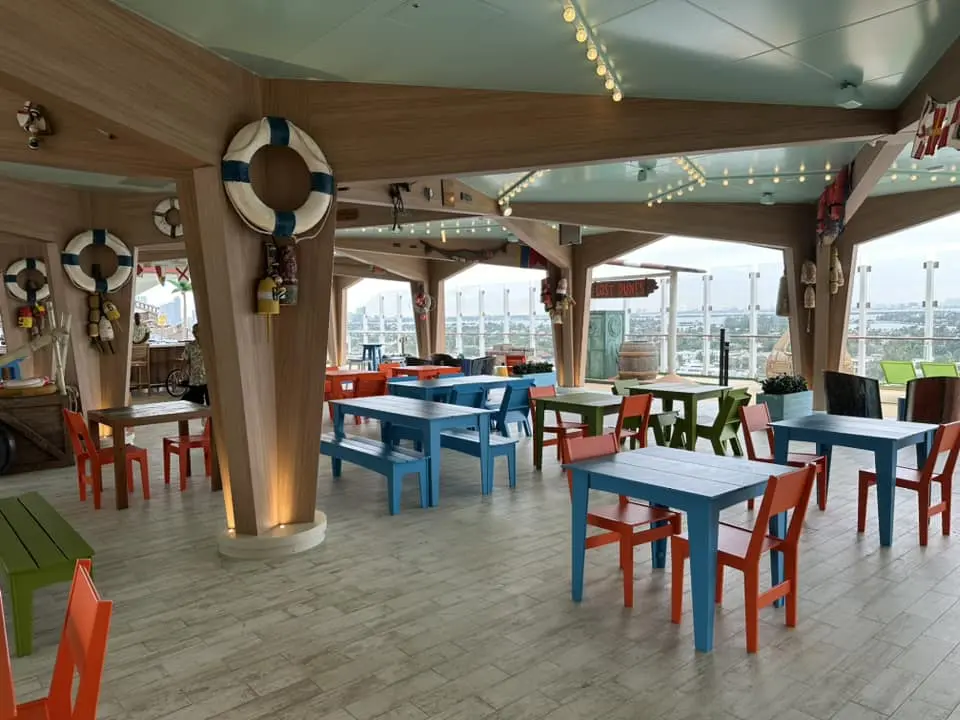 Basecamp restaurant aboard Icon cruise ship, vibrant ocean-view dining as part of your dream cruise vacation.