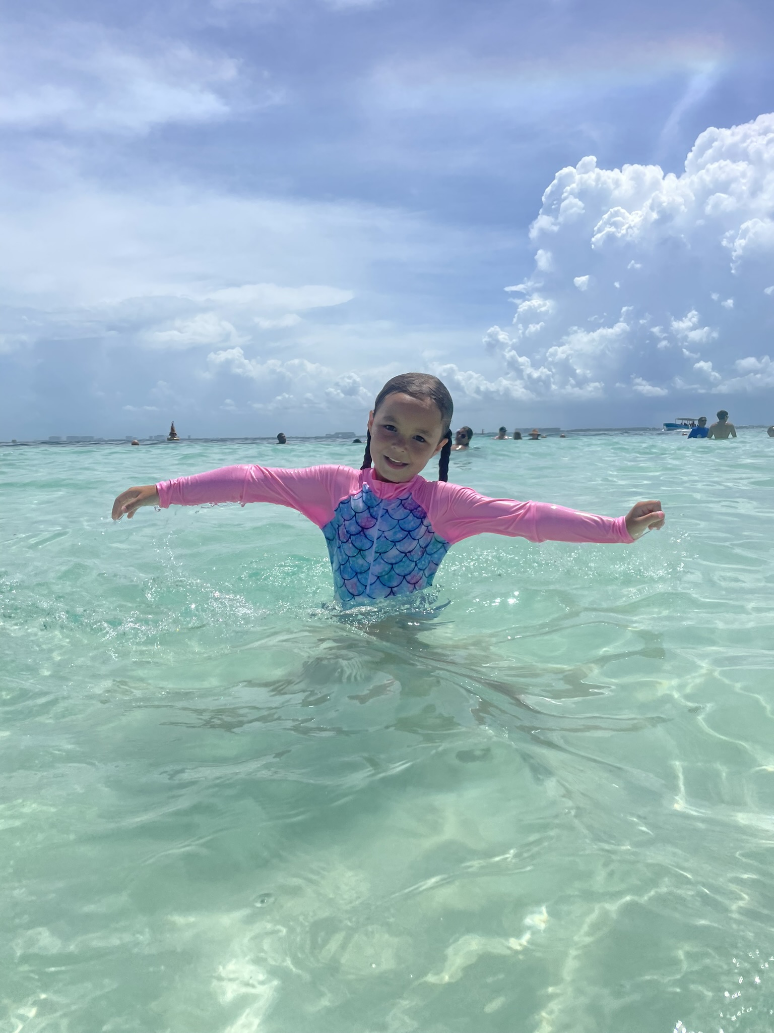 Crystal clear waters of Isla Mujeres, Mexico, swimming at the beachfront with calm turquoise water, showcasing Caribbean Island getaways.